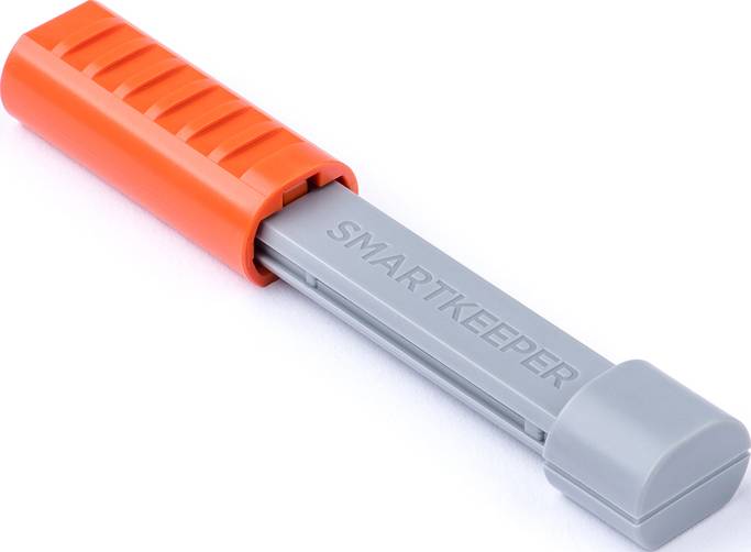 Ein orange-graues Kunststoffgerät mit der Aufschrift 'SMARTKEEPER', vermutlich ein Sicherheits- oder Verschlussmechanismus.