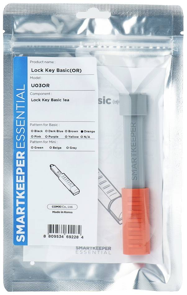 'SmartKeeper'-Verpackung mit einem grauen Sicherheitsschlüssel. Etikett zeigt Produktname, Modellnummer und Farboptionen.