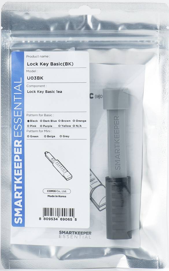Eine Verpackung mit einem grauen 'Lock Key Basic' von Smartkeeper Essential. Produktdetails und Herstellungsland sind sichtbar.