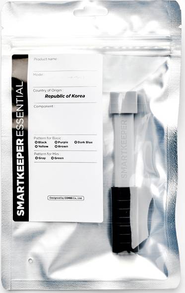Transparente Verpackung mit Zubehör, beschriftet mit 'Smart Keeper Essential, Republic of Korea'. Enthält ein graues Sicherungsgerät.