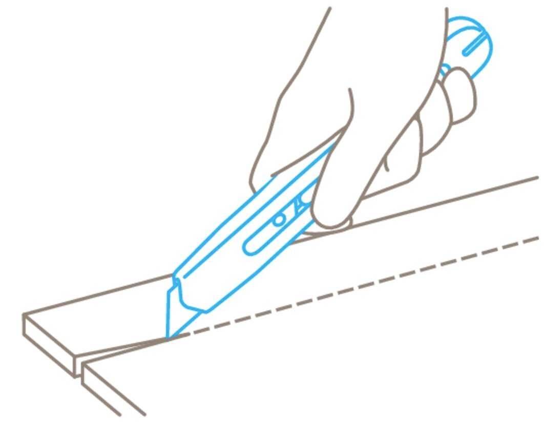 Hand hält einen Teppichmesser, das entlang einer gestrichelten Linie auf einer Oberfläche schneidet.
