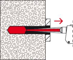 Ein roter Keilanker wird von rechts in einen festen grauen Betonblock eingeschoben. Eine rote Pfeilrichtung zeigt nach links.