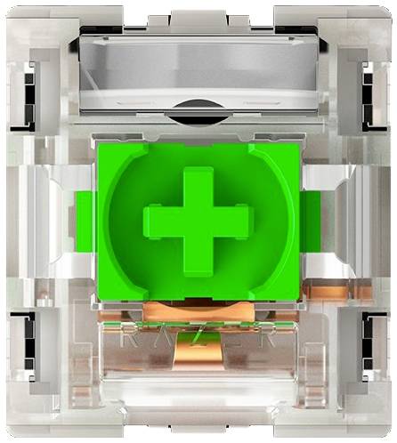 Transparenter mechanischer Tastenschalter mit grünem Kreuz-Mittelstück, umgeben von klaren Kunststoffteilen und Metallkomponenten.