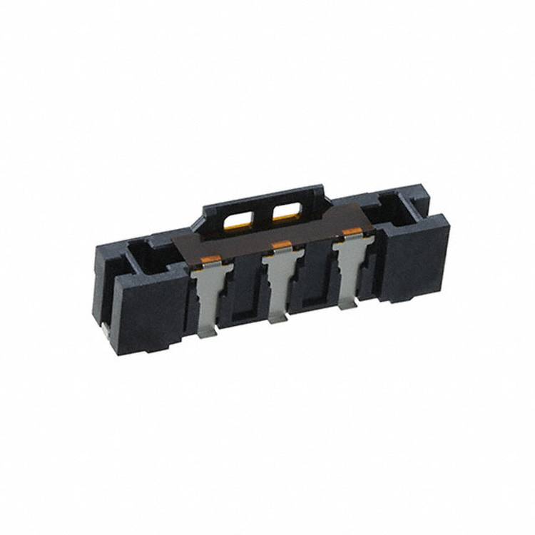 Ein schwarzes rechteckiges elektrisches Bauteil mit vier Metallkonnektoren, wahrscheinlich ein Stecker oder eine Buchse für elektronische Schaltungen.