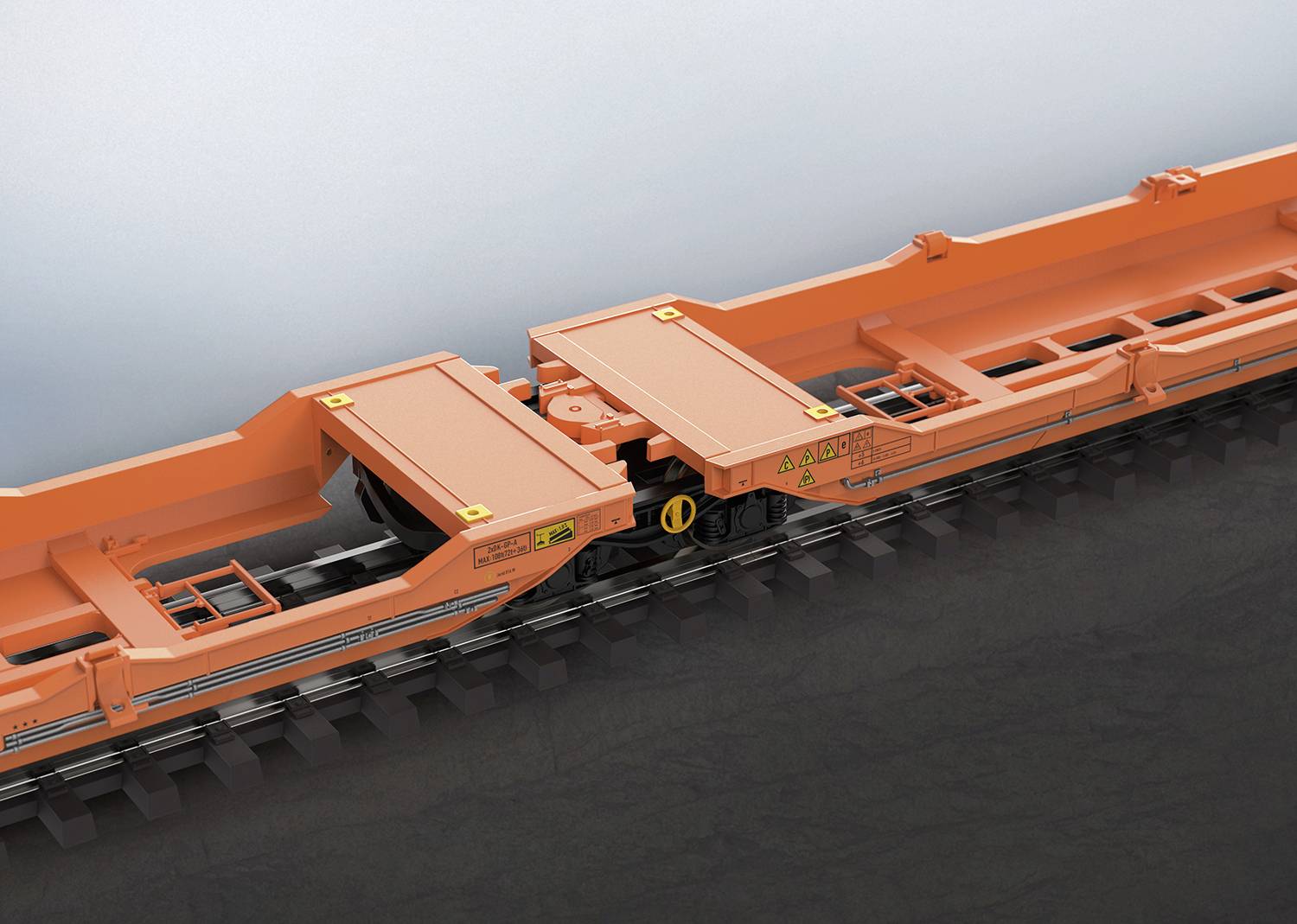 Ein orangefarbener Eisenbahnwaggon-Rahmen, der zeigt, wie zwei Teile über Schienen verbunden sind.