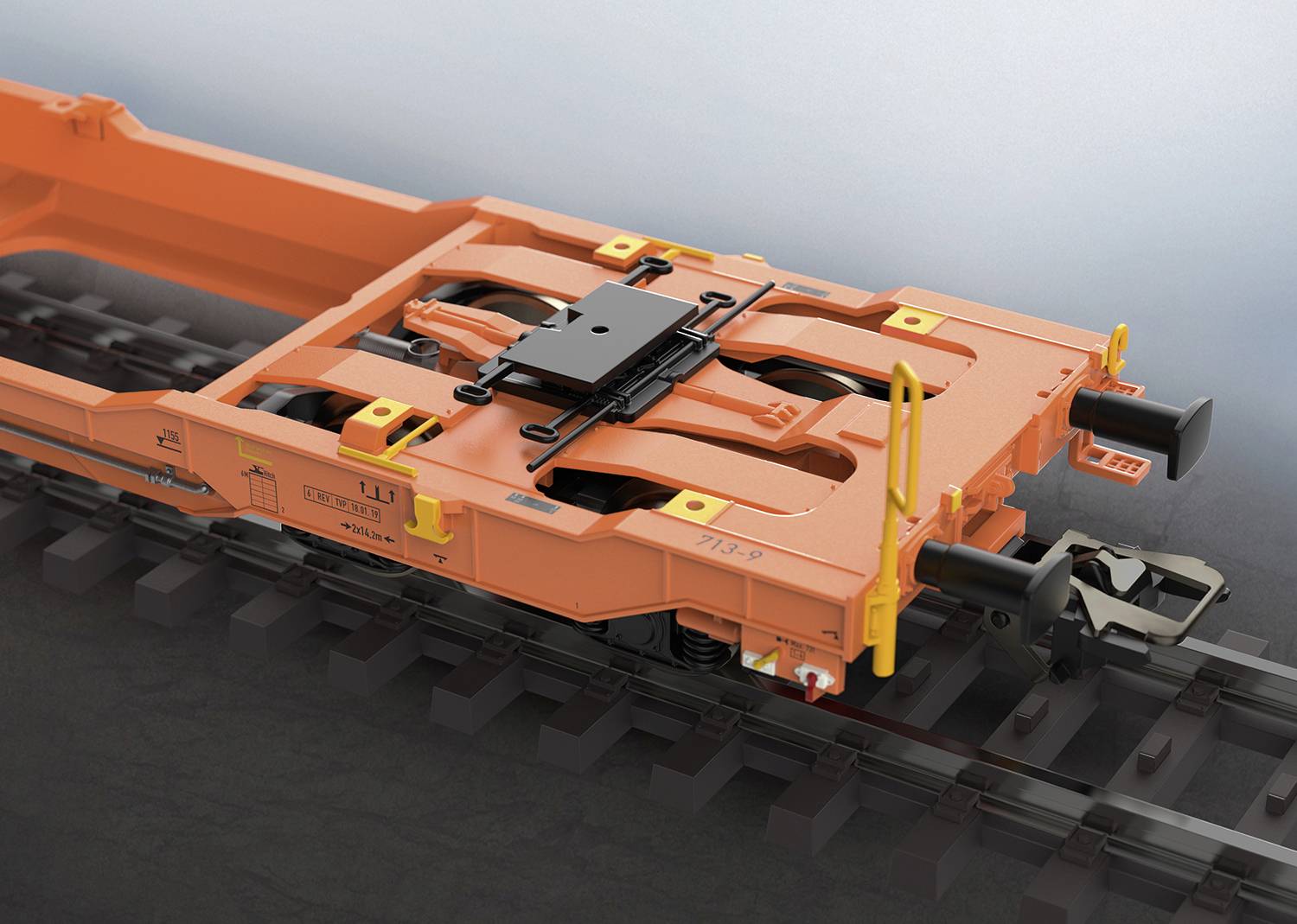 Ein orangefarbener Eisenbahn-Güterwagenrahmen auf Schienen, zeigt eine detaillierte Ansicht des Kupplungs- und Befestigungssystems.