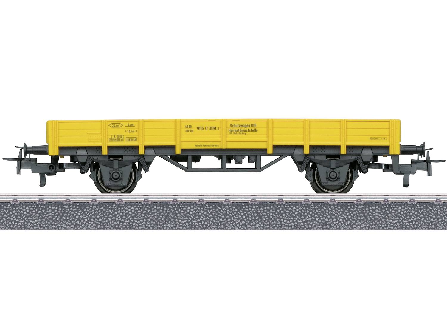 Gelbes Güterwagen-Modell auf Gleis, Seitenansicht.