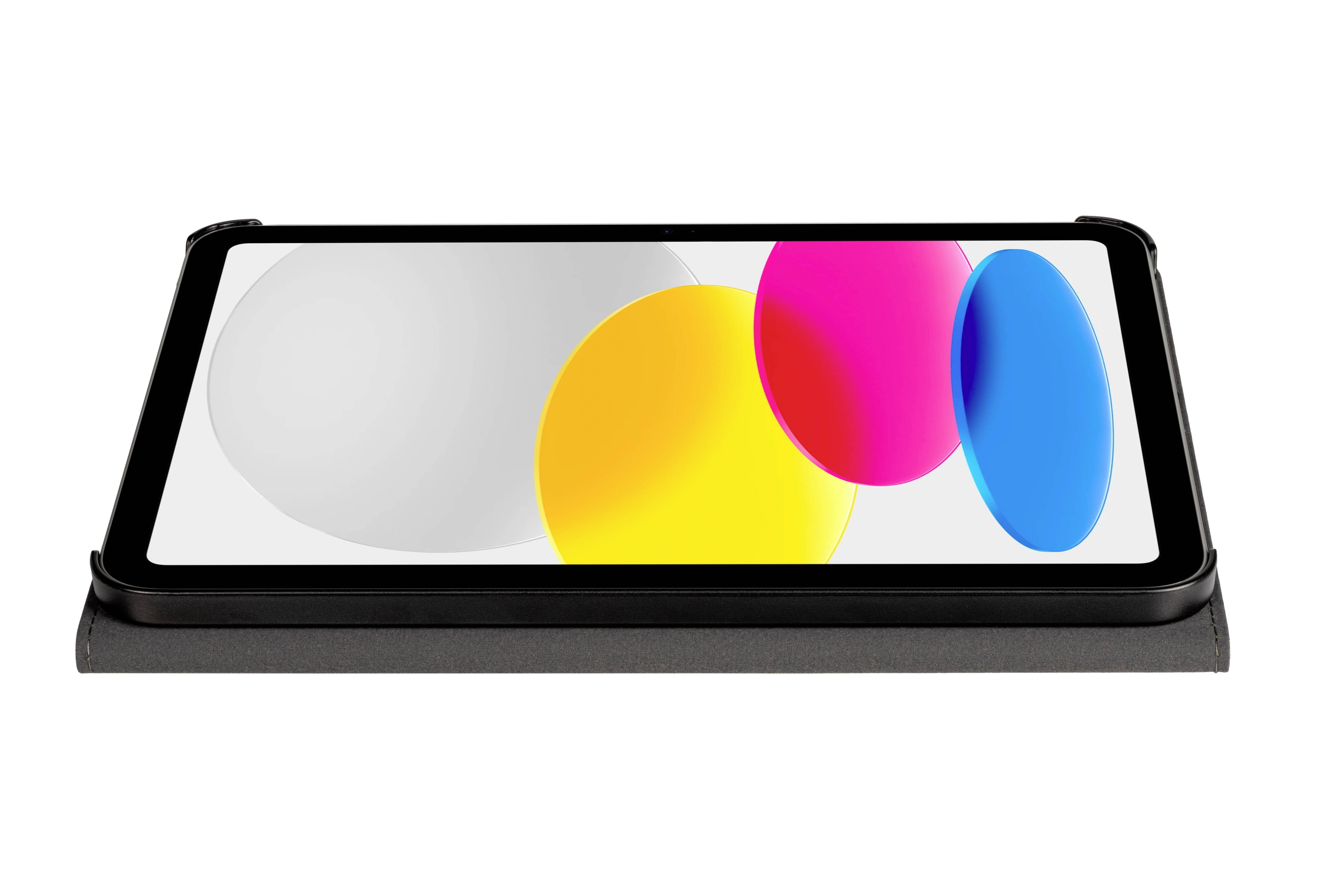 Ein Tablet mit leuchtend buntem Bildschirminhalt, der große Kreise in Gelb, Pink und Blau zeigt. Es liegt auf einer dunklen, flachen Oberfläche.