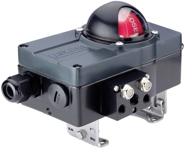 Ein Ventilpositionsanzeiger in grauem Gehäuse mit einer roten Kuppel, die 'CLOSE' anzeigt, Schrauben und einem elektrischen Anschluss.