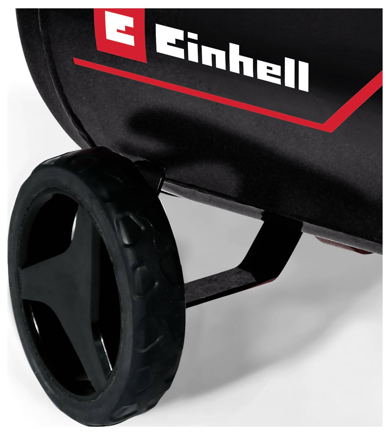 Nahaufnahme einer Einhell-Maschine mit einem schwarzen Rad, das an einem schwarzroten Gehäuse befestigt ist.