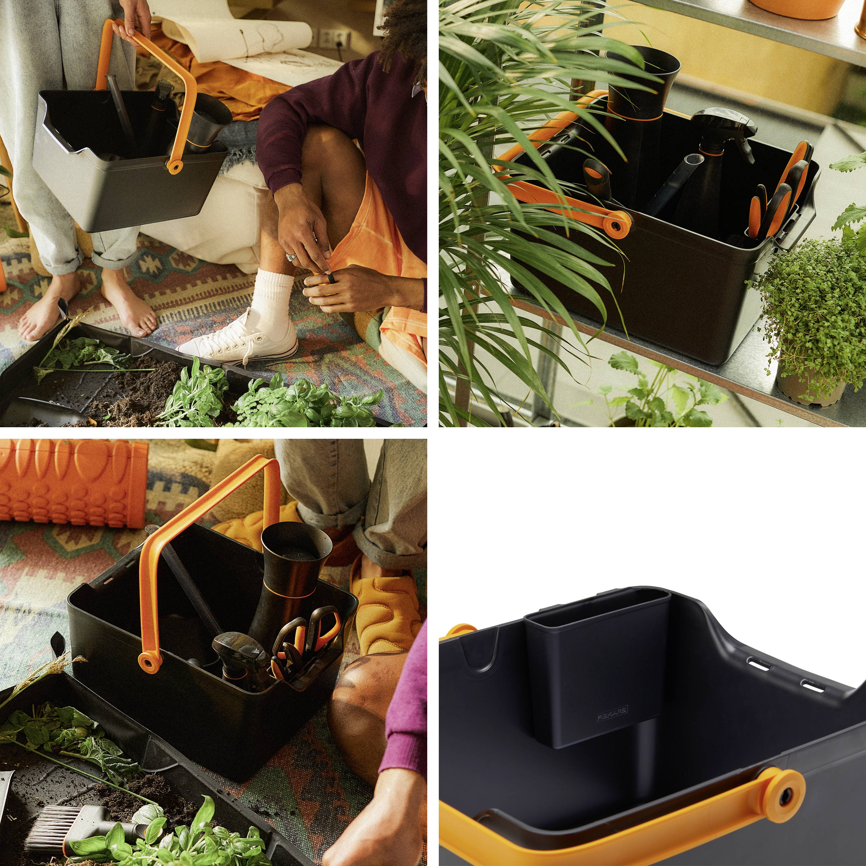 Eine schwarze Gartenbox mit orangefarbenem Griff enthält Werkzeuge und Pflanzen. Personen pflanzen gemeinsam in einem Innenraum.