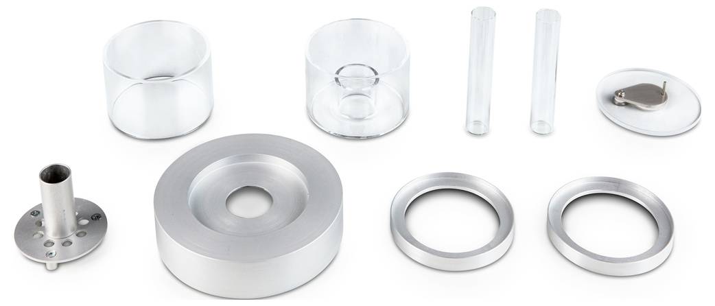 Ein Set aus Glas- und Metallteilen in verschiedenen Formen und Größen, inklusive Ringe, Zylinder und Röhren, auf weißem Hintergrund.