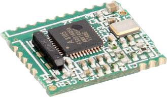 Ein grünes Mikrochip-Modul mit sichtbaren Schaltkreisen und Komponenten, das für elektronische Anwendungen verwendet wird.