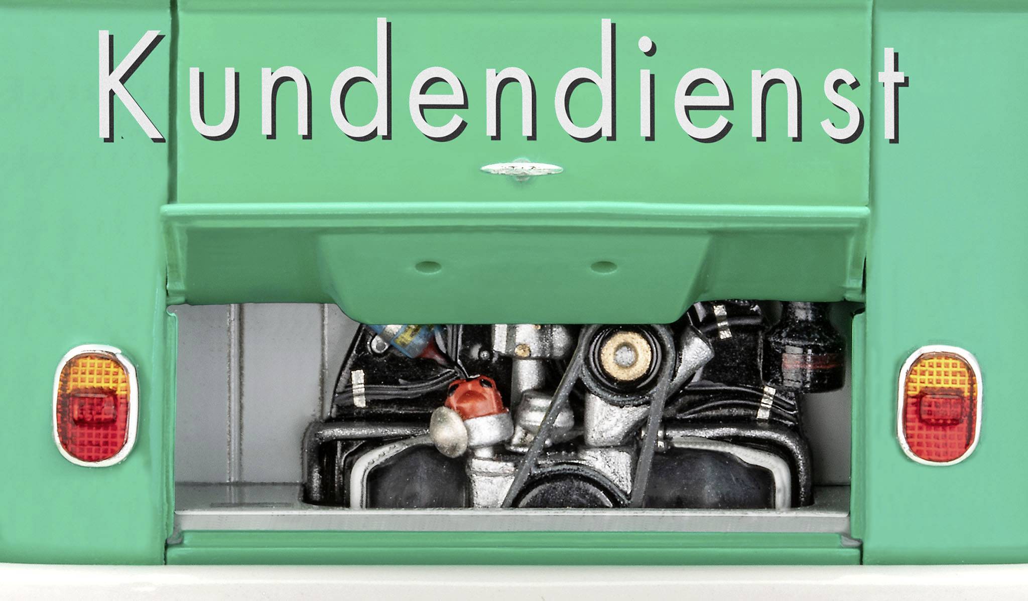 Ein geöffneter grüner Fahrzeugkofferraum zeigt einen Motor. Oben steht das Wort 'Kundendienst'.