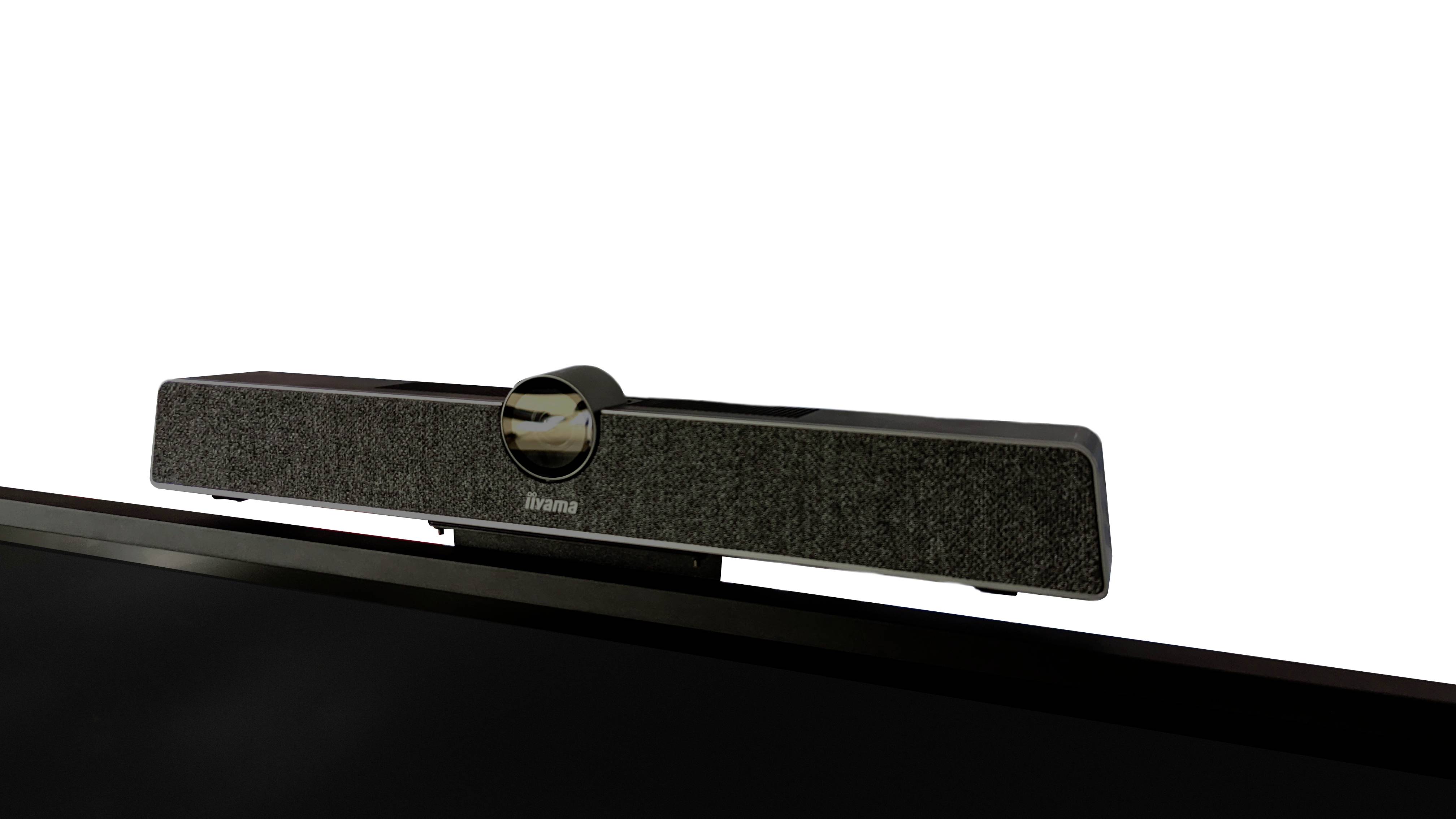 Slimmer schwarzer Soundbar-Lautsprecher wurde an der Oberseite eines Bildschirms befestigt, für eine Platz sparende Audio-Lösung.