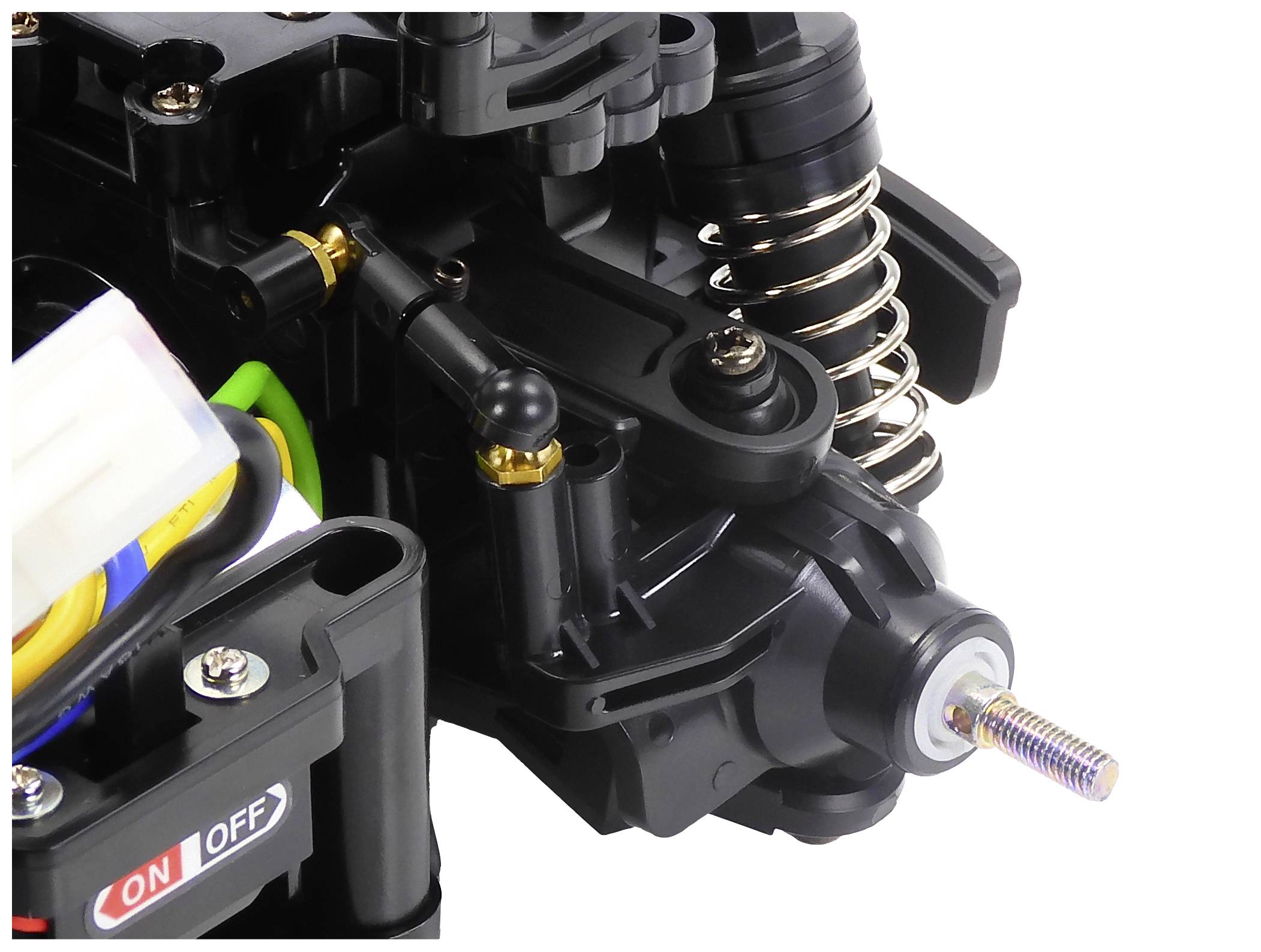 Nahaufnahme eines RC-Autoteils mit Stoßdämpfern, Schrauben und einem 'ON/OFF'-Schalter. Das Bild zeigt technische Details und Struktur.