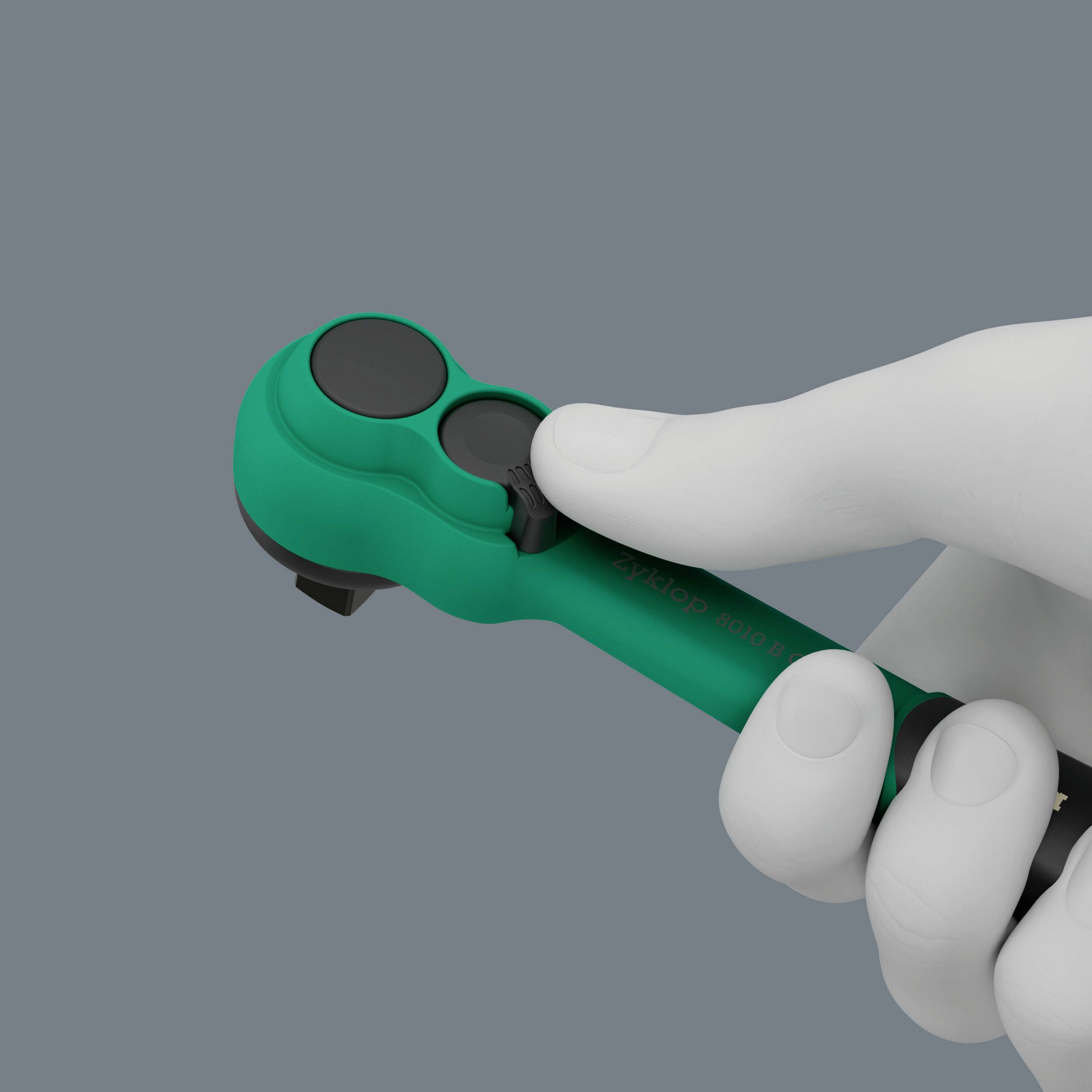 Eine Hand hält einen türkisfarbenen Controller mit schwarzen Knöpfen vor grauem Hintergrund.