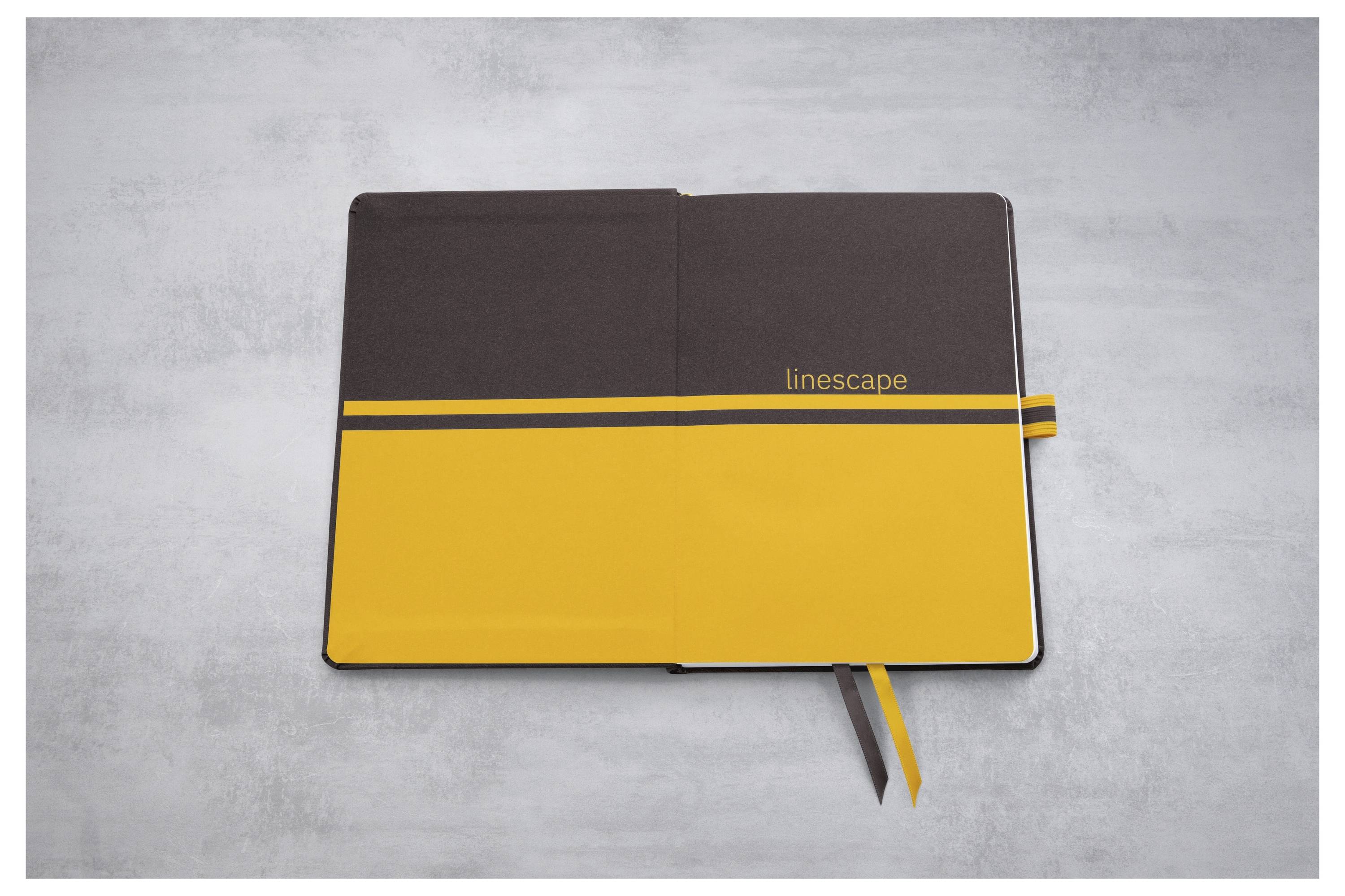 Geschlossenes braun und gelbes Notizbuch mit "Linescape"-Branding, das auf einer grauen Oberfläche liegt, mit sichtbaren Band-Lesezeichen.