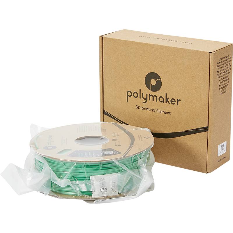 Grüne 3D-Druckerfilament-Rolle neben brauner Polymaker-Verpackung, geeignet für 3D-Druckprojekte.