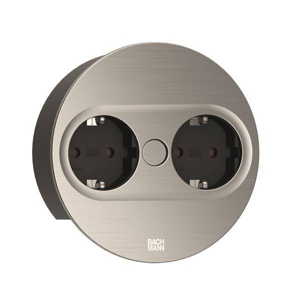 Doppelsteckdose aus Metall in runder Form, geeignet für moderne Innenräume, mit zentralem Schalter über den Steckplätzen.