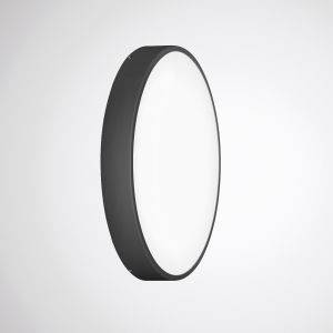 Runde, moderne Wandleuchte mit schwarzem Gehäuse und weißer Lichtfläche, an einer hellgrauen Wand montiert.