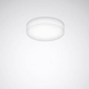 Eine runde, weiße Deckenleuchte leuchtet gegen eine schlichte, graue Wand.