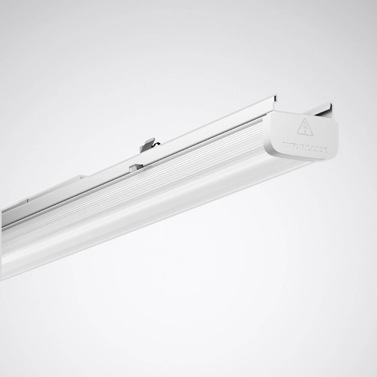 Ein weißes LED-Lichtmodul mit rechteckiger länglicher Form und einem kleinen Warnsymbol auf der Seite, montiert an einer Schiene.