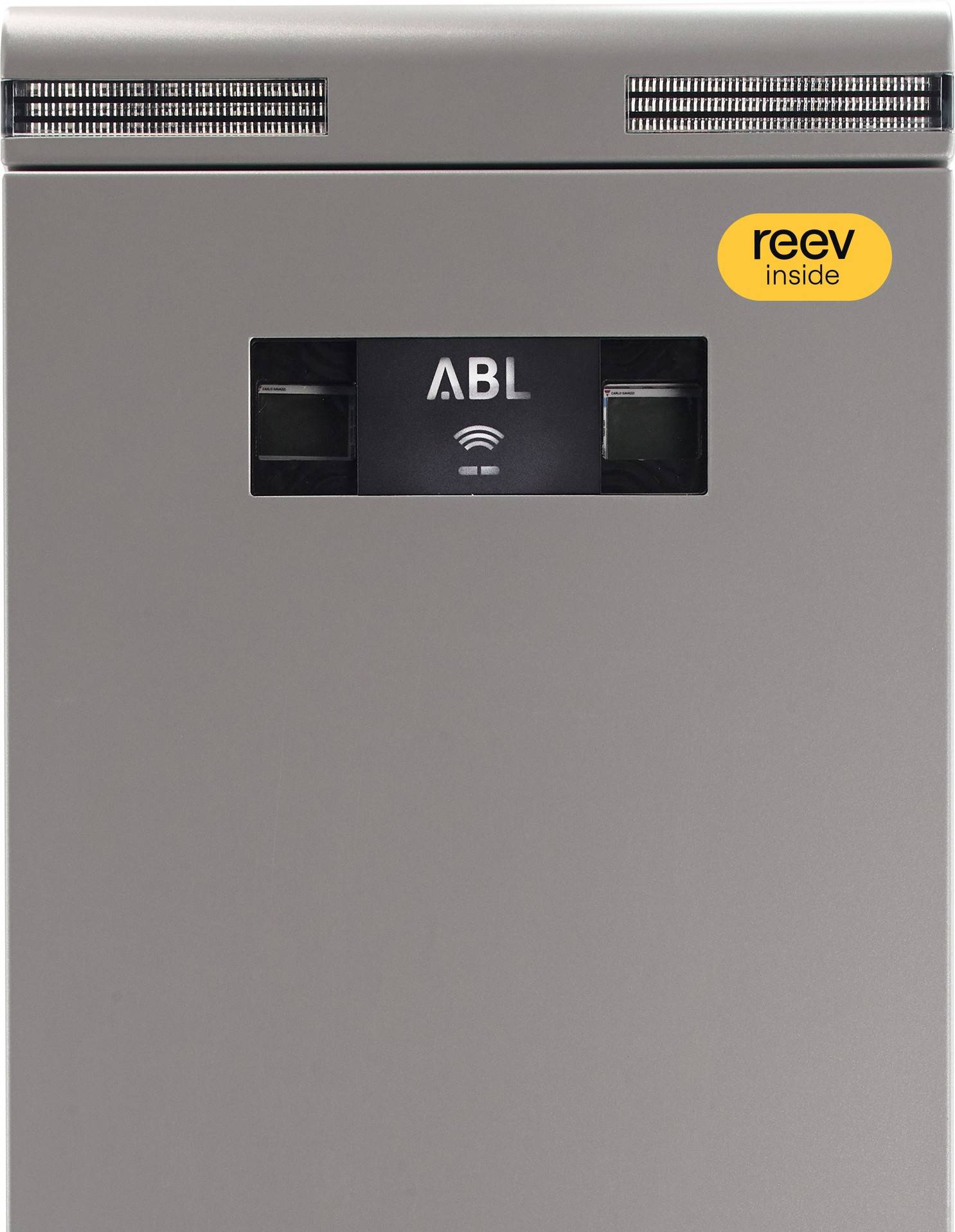 Graue E-Ladestation mit Display und WLAN-Symbol. Oben rechts ein gelber Aufkleber mit der Aufschrift 'reev inside'.