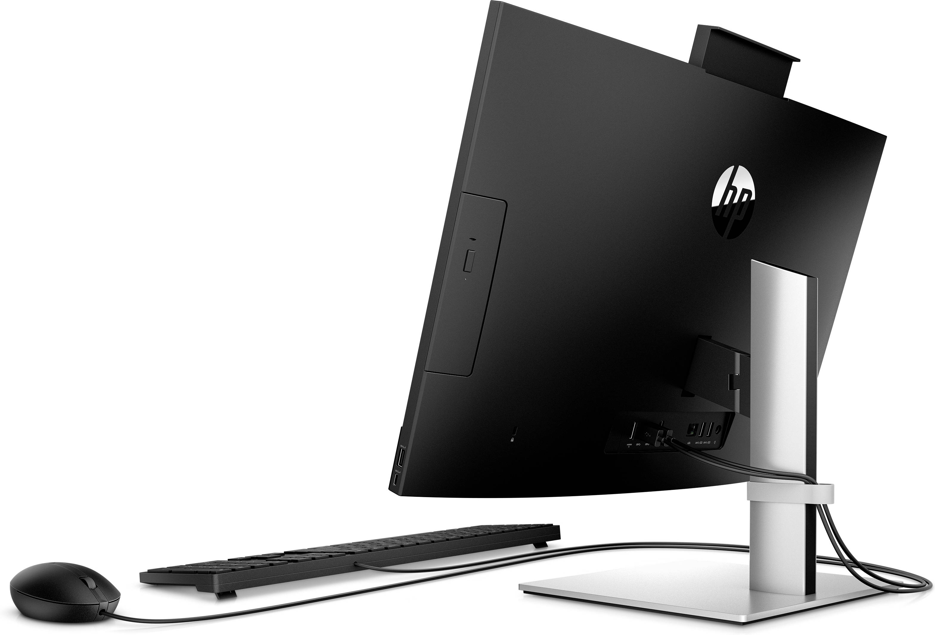 Ein All-in-One-Desktop-Computer von hinten gezeigt. Schwarzes Design mit integriertem Monitor, Tastatur und Maus. Kabelverbindung sichtbar.