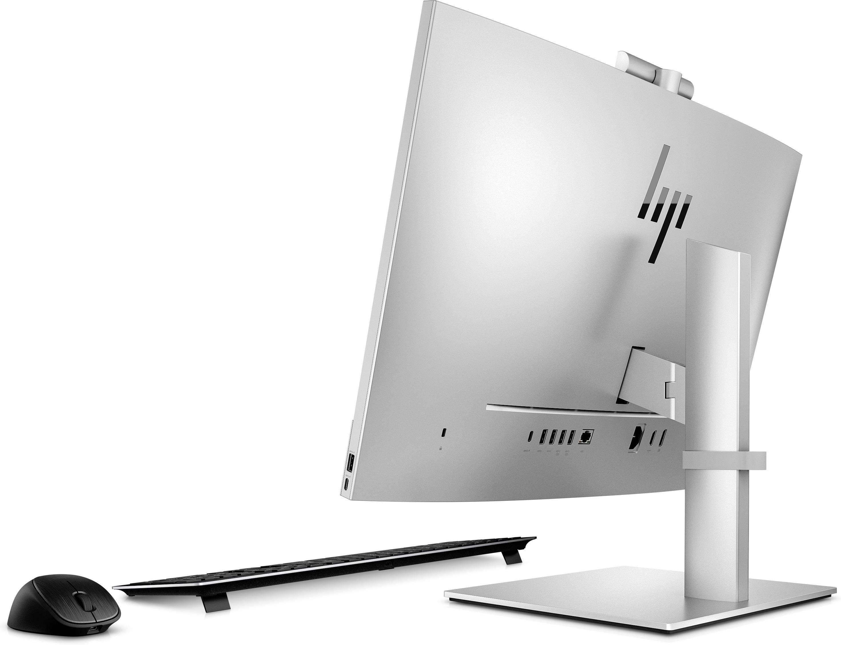 Ein eleganter, weißer Desktop-PC mit schlankem Design von der Seite betrachtet, neben einer kabellosen Maus und Tastatur.