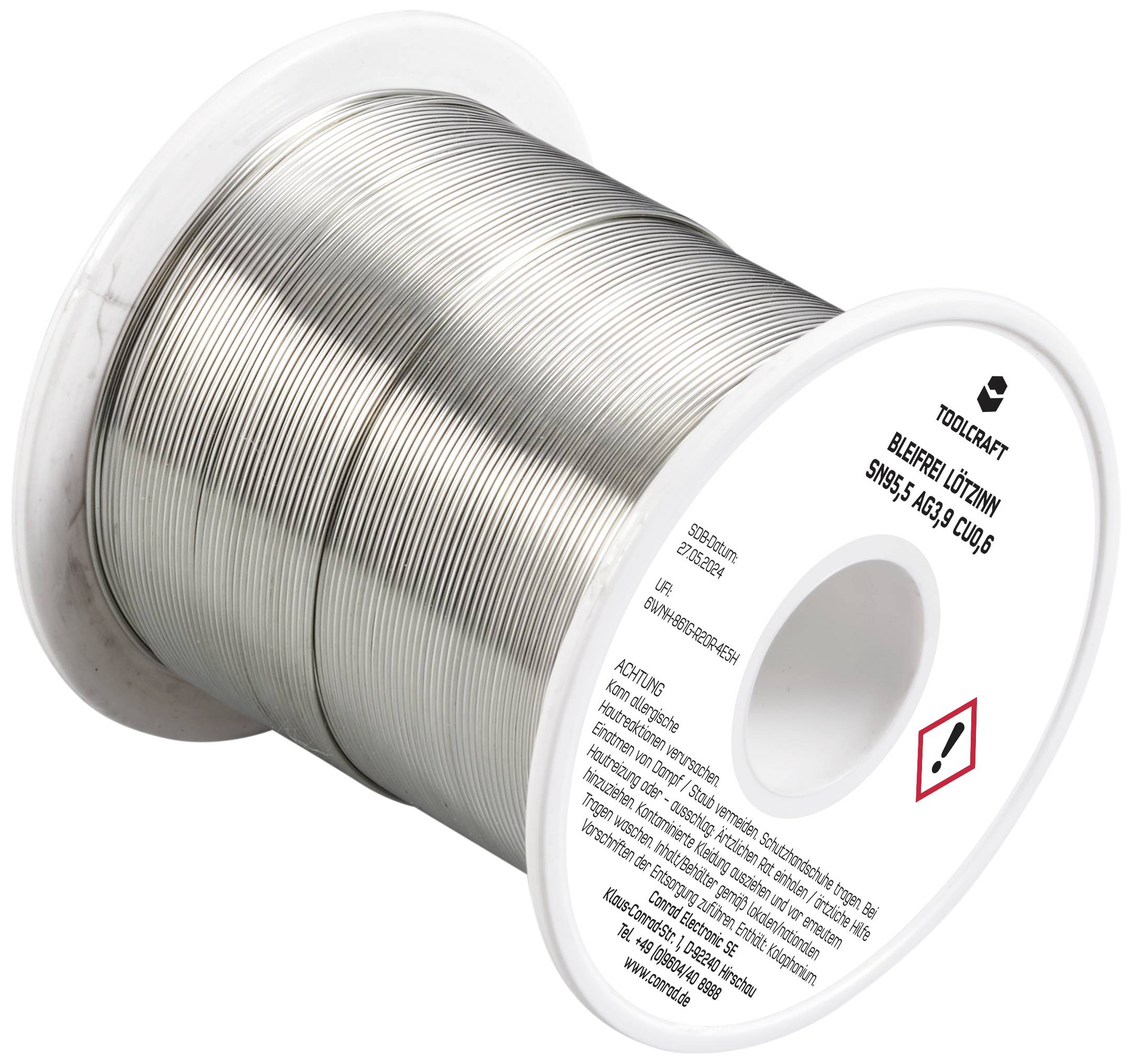 Eine Rolle Lötzinn mit silbernem Draht, umgeben von einer Kunststoffspule. Aufschrift mit Sicherheitshinweisen ist auf der Spule sichtbar.