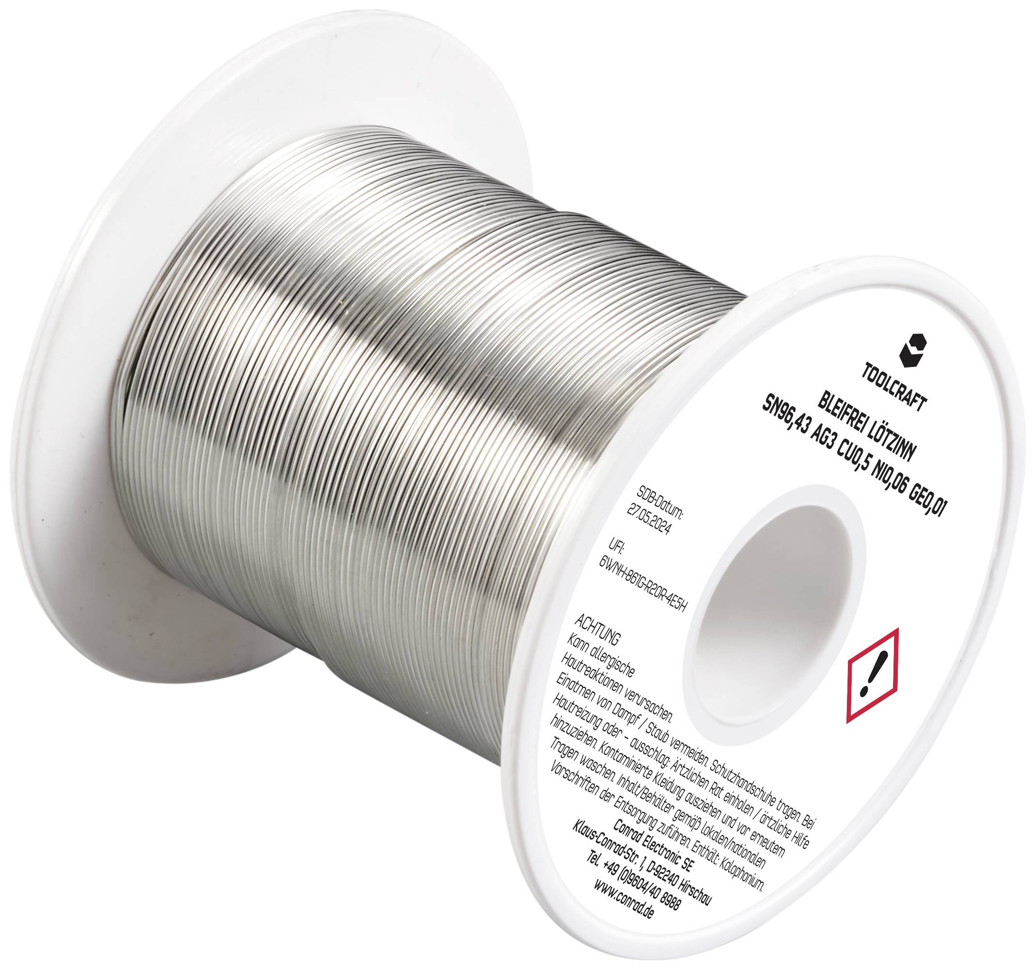 Lötdrahtrolle mit silbernem Draht und Warnhinweisen auf der Spule.