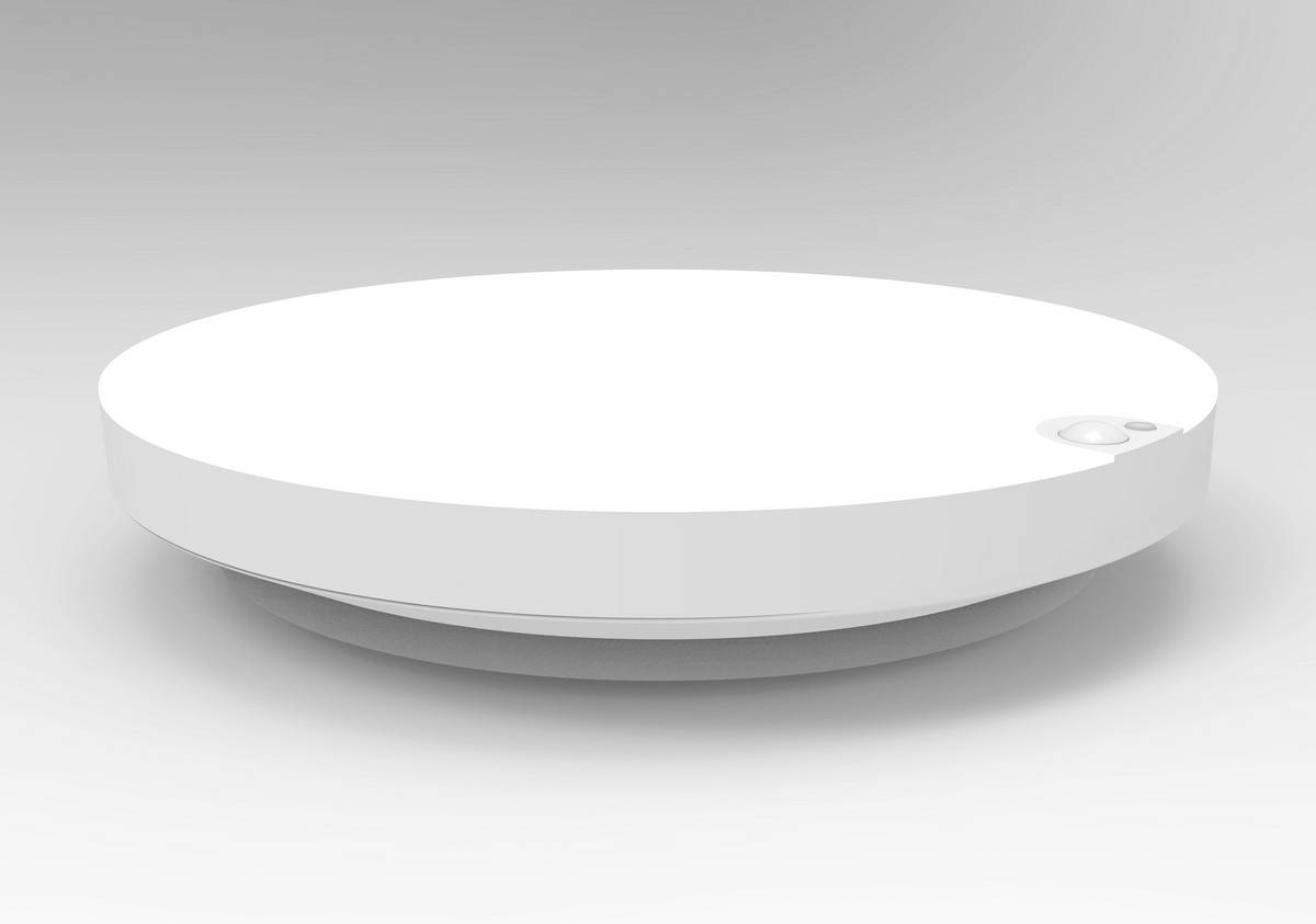 Ein runder, weißer Rauchmelder auf einer grauen Fläche, in Seitenansicht gezeigt.