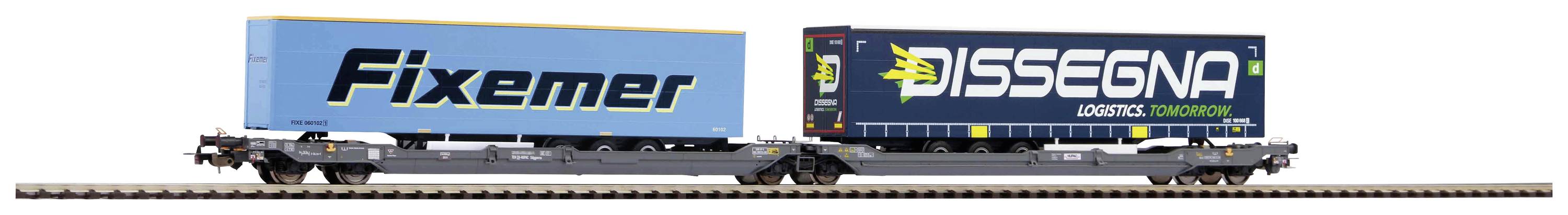 Modelleisenbahn: Zwei Güterwaggons tragen Container, einer mit 'Fixemer'-Aufschrift, der andere mit 'Dissegna Logistics' auf einem Schienenabschnitt.