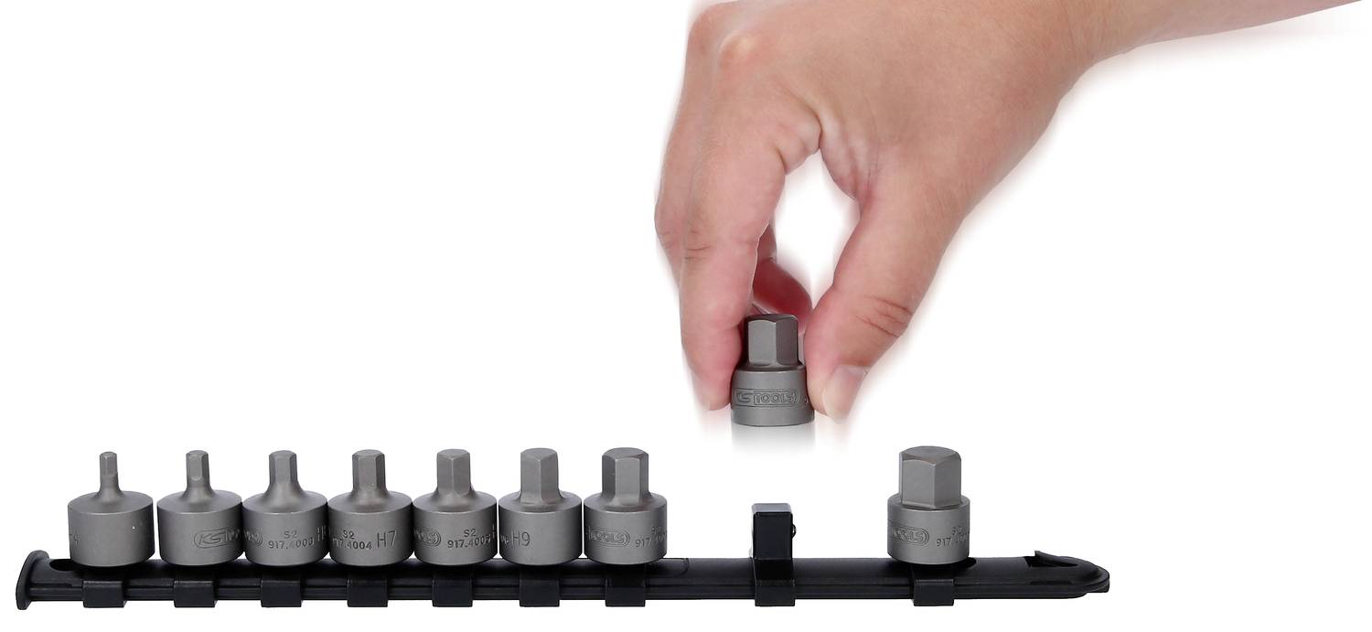 Eine Hand hebt eine Sechskant-Stecknuss von einer Reihe ähnlicher Werkzeuge auf einer Halterung.
