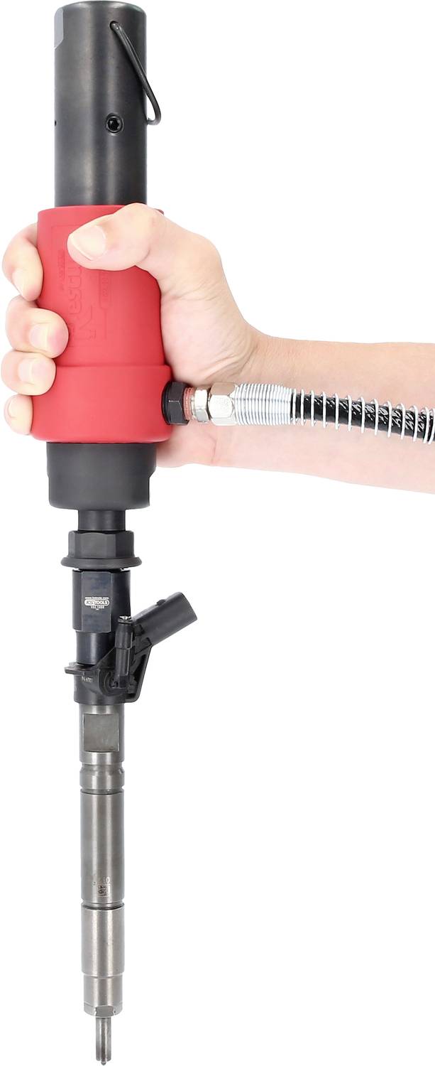 Eine Hand hält ein rotes, zylindrisches Werkzeug mit einem langen, schlanken Metallaufsatz und einem flexiblen Schlauch.