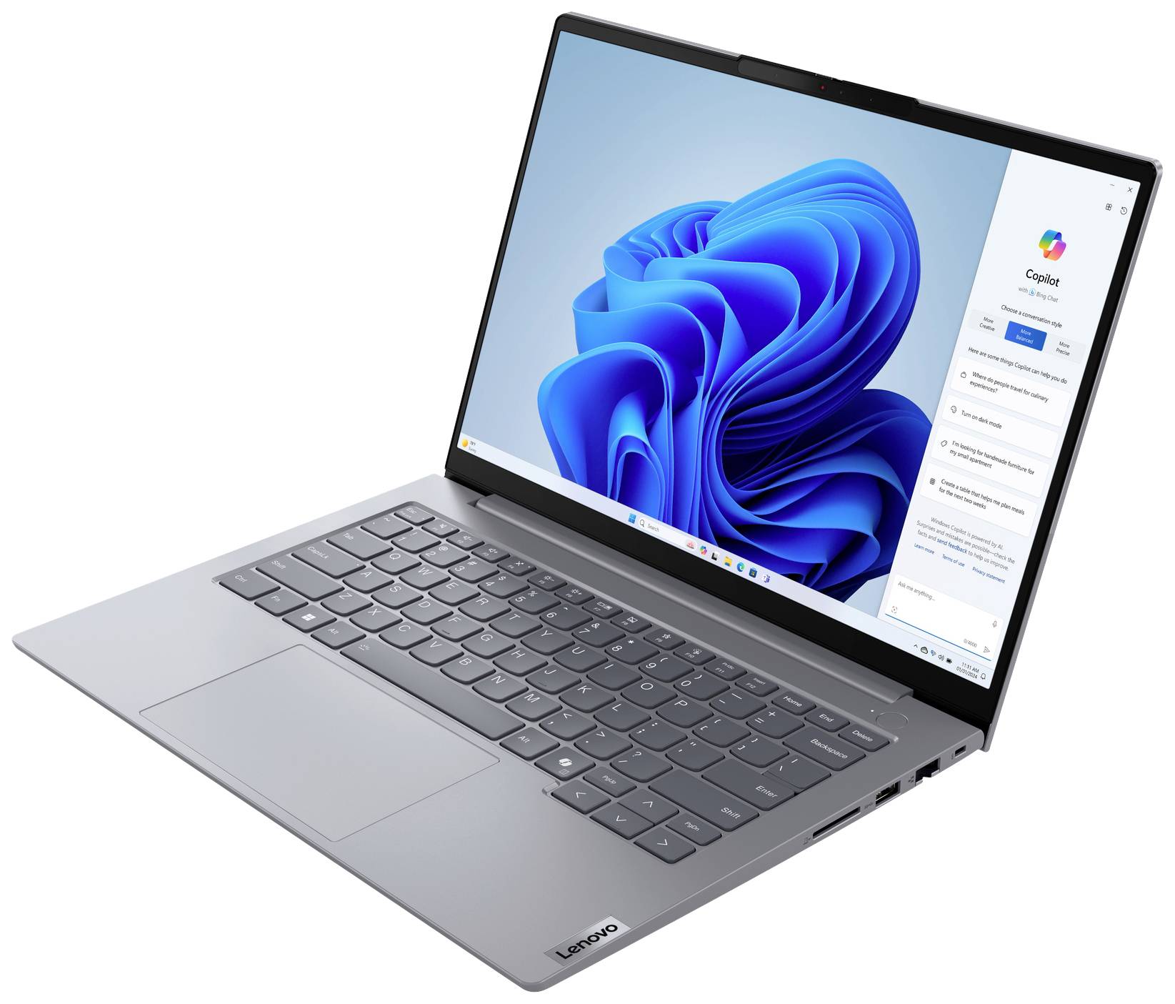 Ein grauer Laptop mit geöffneter Windows 11 Startseite auf dem Bildschirm. Tastatur und Trackpad sind sichtbar.