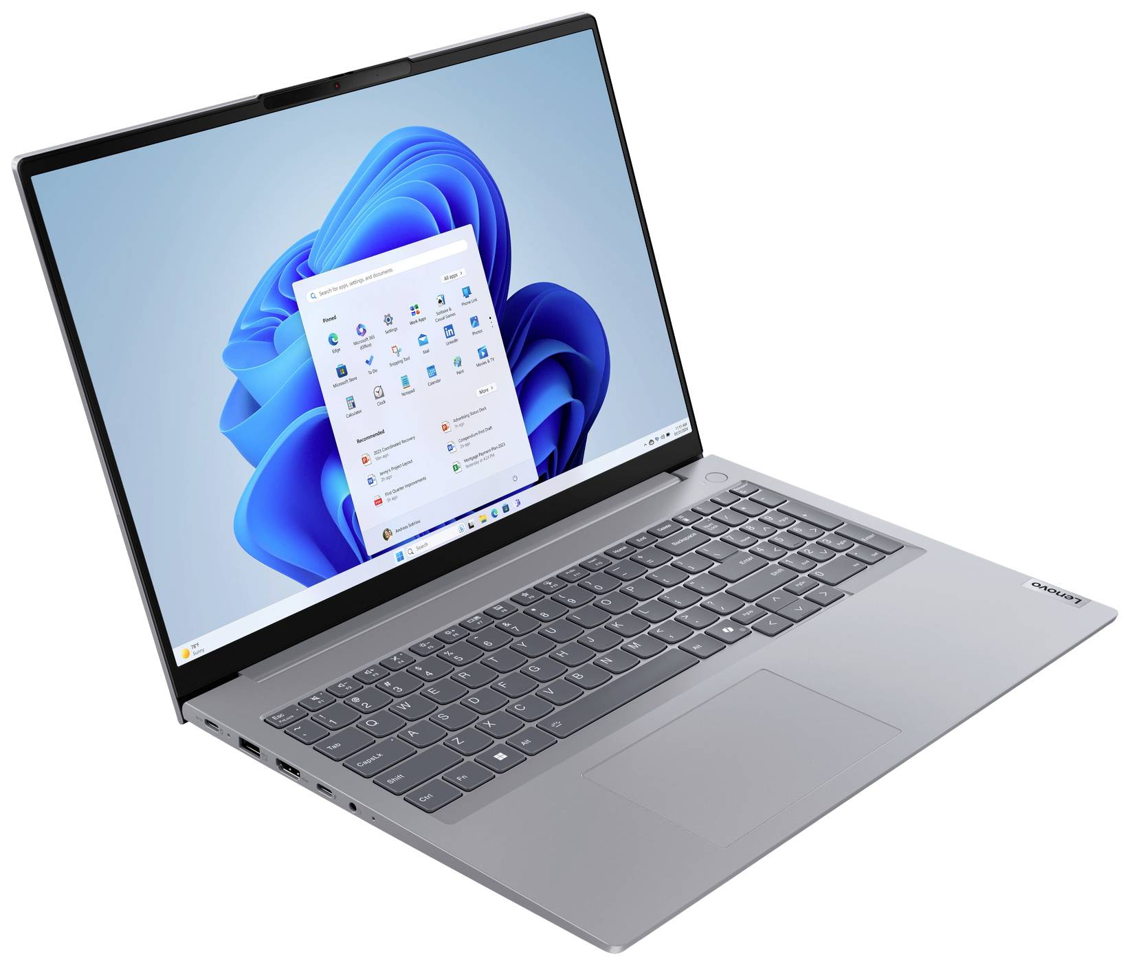 Ein geöffnetes Laptop zeigt den Startbildschirm von Windows 11. Das Gerät hat eine silberne Tastatur und einen großen, farbigen Bildschirm.