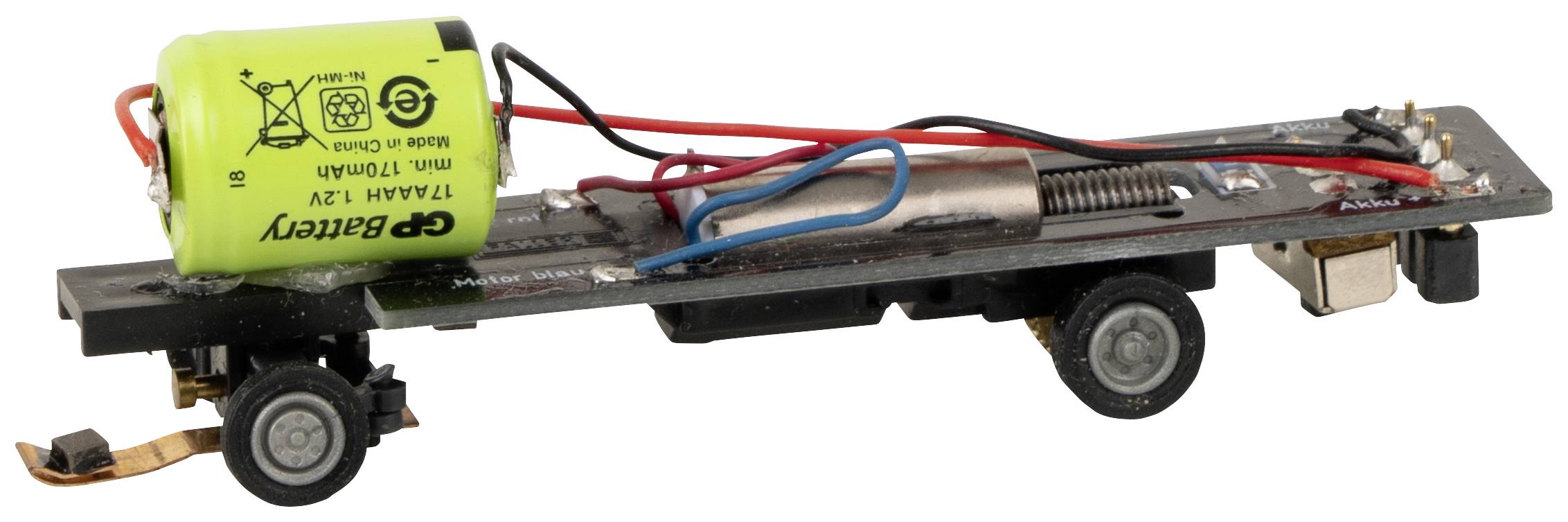 Spielzeugautochassis mit Motor, Batterie und Kabeln. Keine Karosserie oder Räder, verdeutlicht die interne Mechanik.