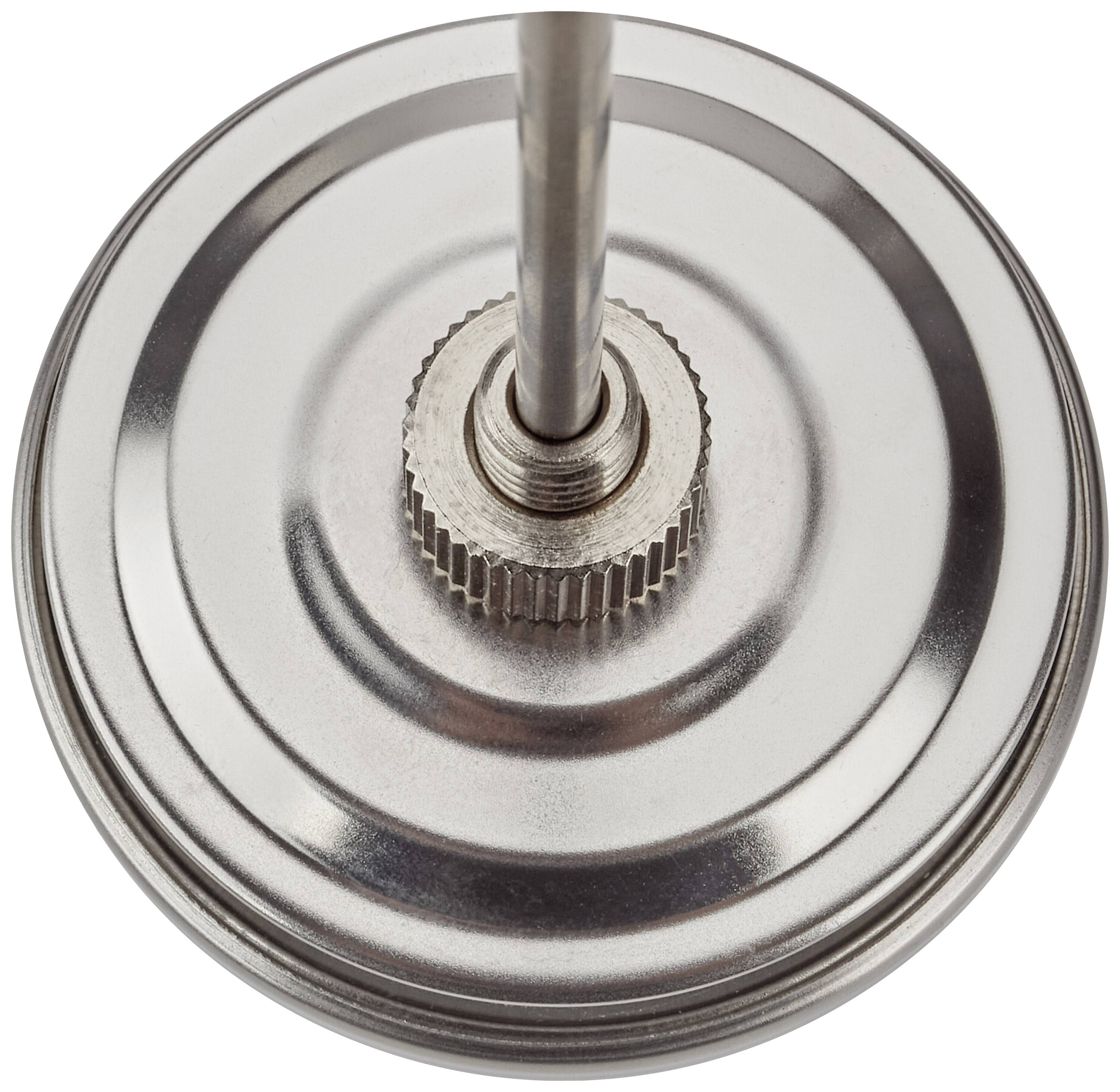 Nahaufnahme eines runden, metallischen Objekts mit einer Stange in der Mitte. Es könnte Teil eines mechanischen oder technischen Geräts sein.