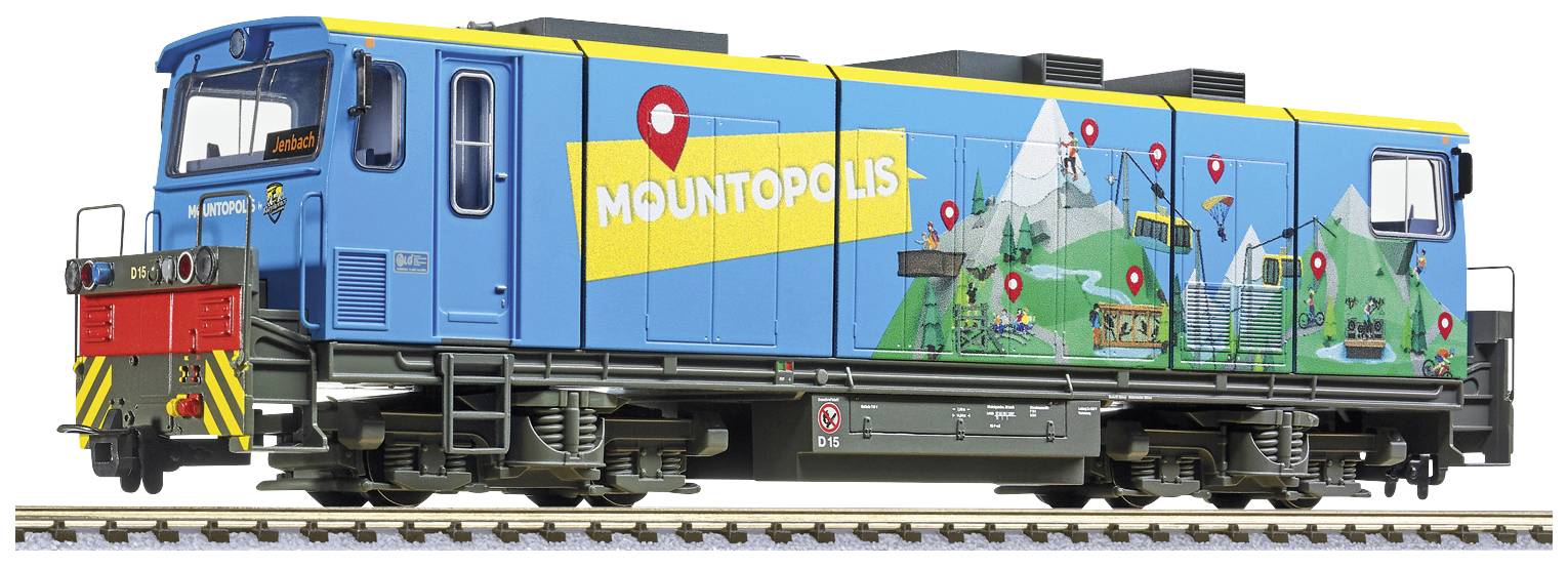 Ein Modellzug in blau-gelben Farben mit der Aufschrift 'Mountopolis'. Auf der Seite sind Bergmotive und rote Markierungen abgebildet.