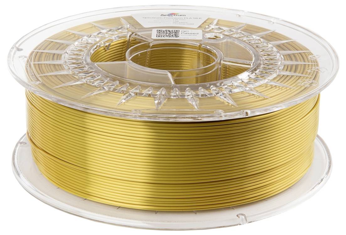 Filamentspule mit goldfarbenem 3D-Druckmaterial, in durchsichtiger Kunststoffverpackung.