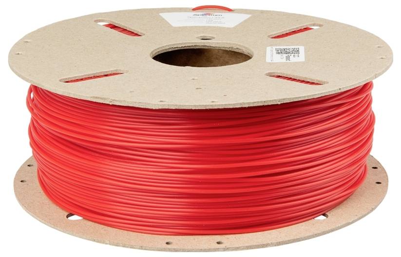 Ein großer Pappspulenkern mit aufgewickeltem, rotem Kunststofffilament, verwendet für 3D-Drucker.