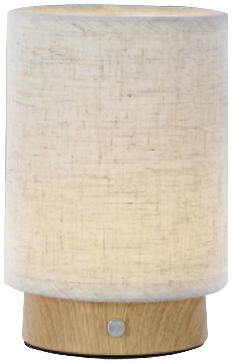 Eine Tischlampe mit einem zylindrischen, cremeweißen Stoffschirm und einem Holzboden. Die Lampe ist eingeschaltet und leuchtet warm.