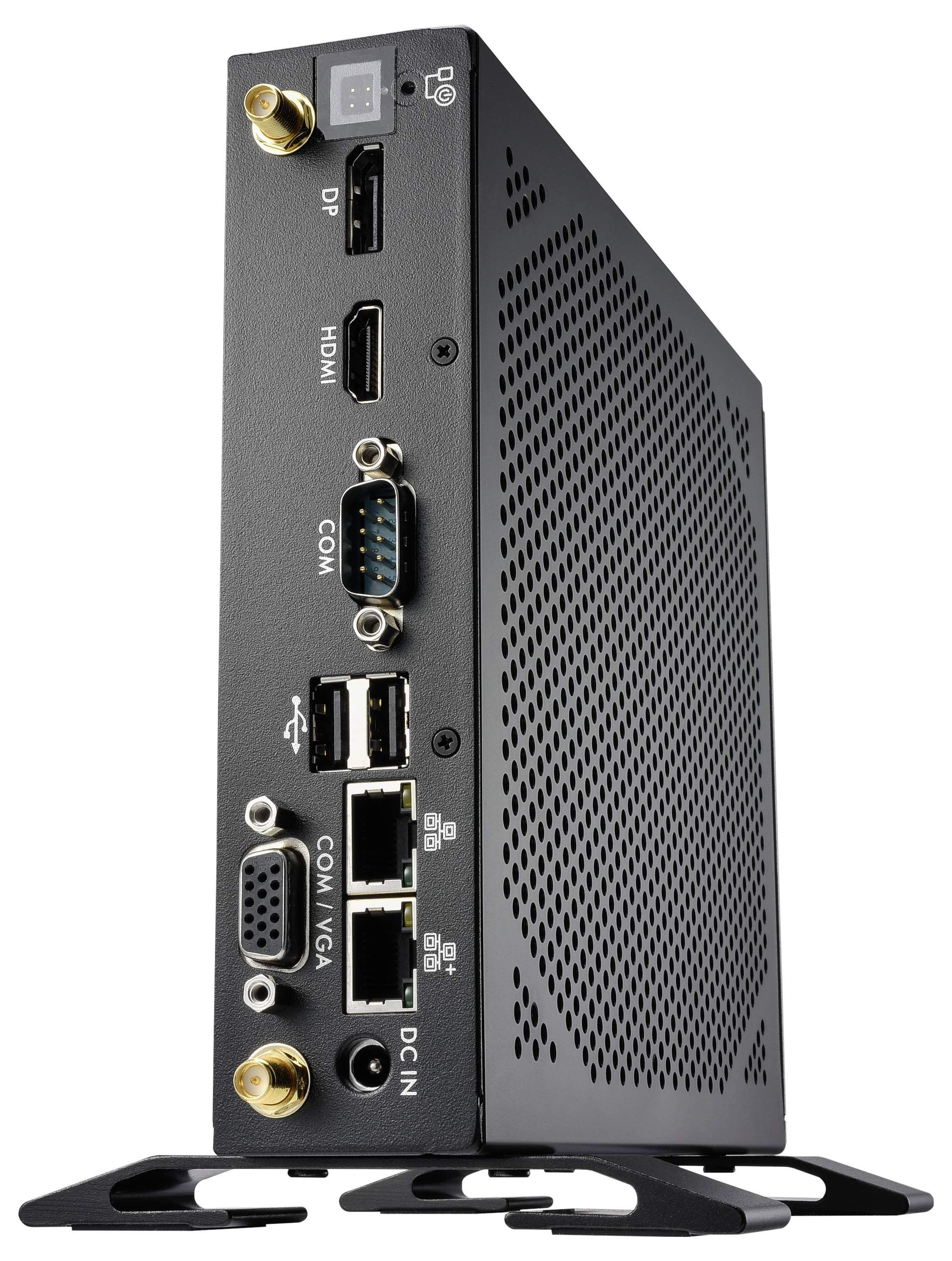 Ein schwarzer Mini-PC steht aufrecht. Sichtbare Anschlüsse sind DP, HDMI, COM, USB, LAN, VGA, und DC-IN. Gerät hat Lüftungsschlitze.