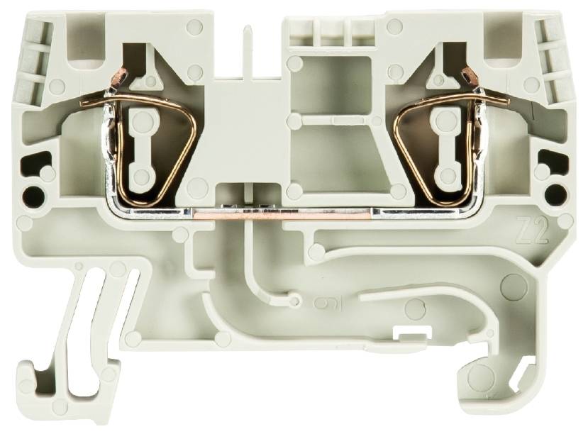 Graues, rechteckiges Kunststoffteil mit Metallkontakten und Hohlräumen. Es handelt sich um eine elektrische Klemme.