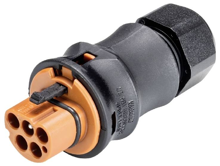 Ein schwarzer, zylindrischer Stecker mit orangenem Kopf und mehreren Anschlussöffnungen. An der Seite steht 'WARNING'.