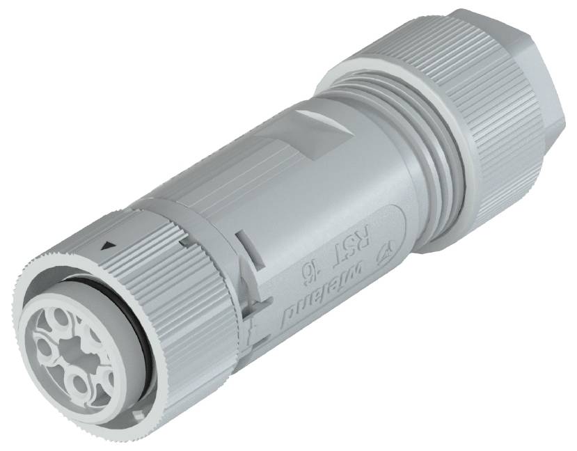 Ein grauer, zylindrischer Stecker mit mehreren Anschlussöffnungen.