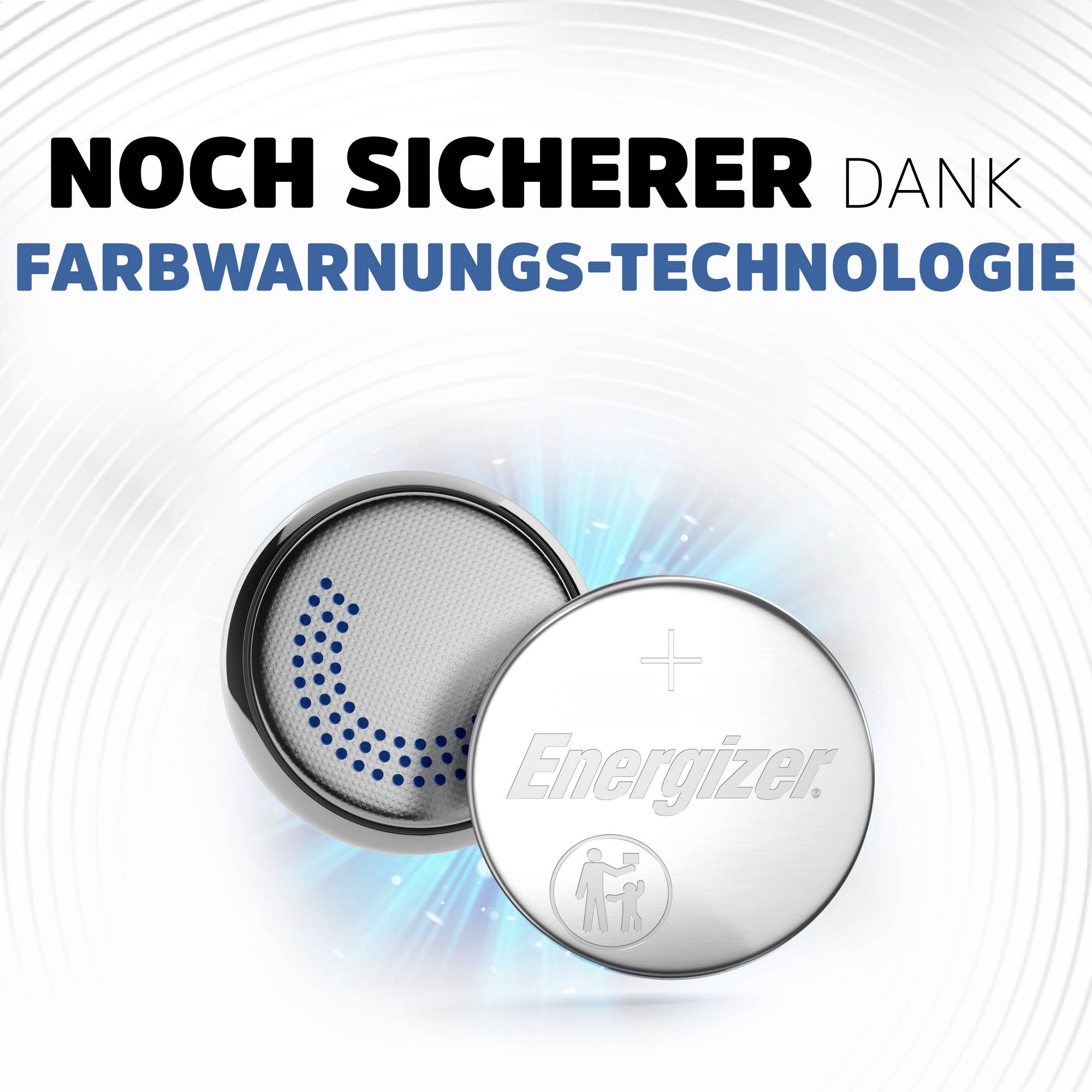 Zwei Knopfzellenbatterien, eine mit blauer Farbwarnung, daneben ein Text: 'Noch sicherer dank Farbwarnungs-Technologie'.