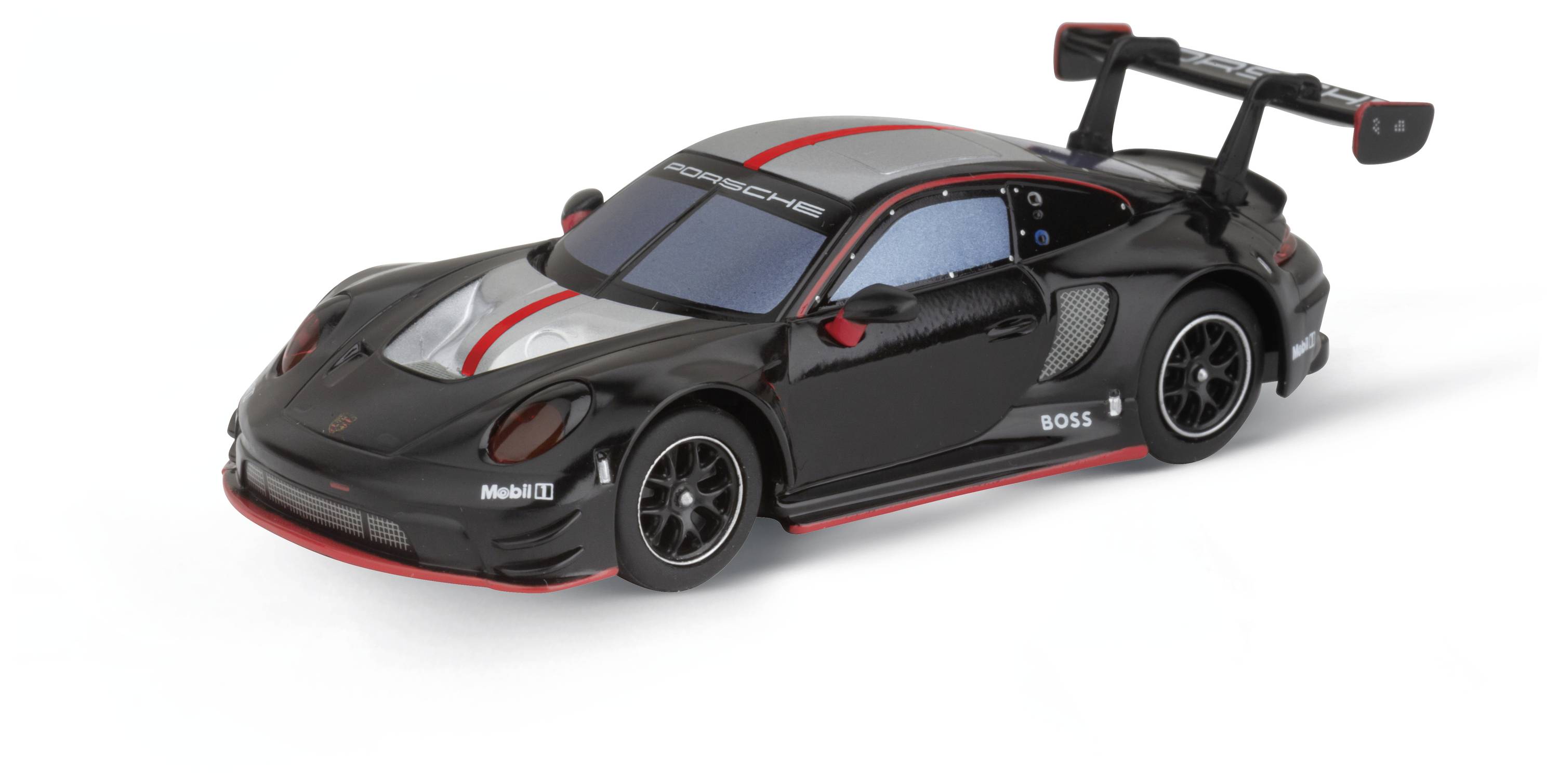 Ein schwarzes Modellauto eines Sportwagens mit roten Akzenten und großem Heckspoiler, auf einer weißen Oberfläche präsentiert.